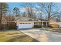 A charming brick home with an attached garage and mature trees at 767 Smithstone Se Rd, Marietta, GA 30067