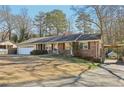 Charming brick home with a well-maintained lawn and a covered carport at 767 Smithstone Se Rd, Marietta, GA 30067