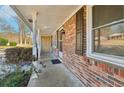 Inviting front porch with brick siding, white columns, and a welcoming entrance at 767 Smithstone Se Rd, Marietta, GA 30067