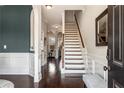 Inviting home foyer with gleaming hardwood floors, staircase and white trim at 821 Bufflehead Ct, Stockbridge, GA 30281