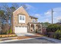 Beautiful brick home with a two-car garage and a cozy front porch at , Dunwoody, GA 30338