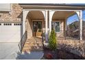 Inviting front porch with brick steps, iron railings, and a stylish entryway at , Dunwoody, GA 30338