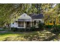 Charming traditional home with a screened porch, nestled amongst mature trees and lush greenery at 1840 Madrona Nw St, Atlanta, GA 30318