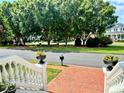 Scenic street view featuring mature trees, charming homes, and a well-maintained brick sidewalk at 3987 St Georges Ct, Duluth, GA 30096