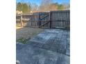 The fenced backyard features a mix of concrete and stone pavers and a small grass area at 1546 Mine Run, Hampton, GA 30228