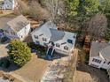 An aerial view of a charming home with an inviting driveway and beautiful landscaping at 239 Taylors Farm Dr, Canton, GA 30115