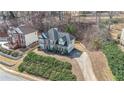 Overhead shot of a brick home nestled among trees, showcasing its driveway and well-maintained yard at 349 Azalea Chase Dr, Suwanee, GA 30024