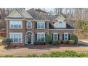 Attractive brick home featuring a symmetrical design, a well-kept lawn, and lush landscaping for great curb appeal at 349 Azalea Chase Dr, Suwanee, GA 30024