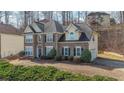Beautifully landscaped two-story home with a brick facade, a charming entry, and an attached side-entry garage at 349 Azalea Chase Dr, Suwanee, GA 30024