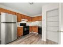 Functional kitchen featuring wooden cabinetry, stainless steel refrigerator, and modern appliances at 858 Heritage Valley Rd, Norcross, GA 30093