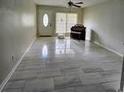 Bright living room features large sliding doors and neutral tile flooring at 6658 Collins Ct, Riverdale, GA 30274