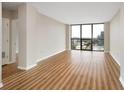 Spacious living room with hardwood floors and large windows offering panoramic city views at 1280 W Peachtree Nw St # 2302, Atlanta, GA 30309