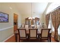 Formal dining room with wood floors, chandelier, and ample natural light at 4584 Madison Place Ln, Atlanta, GA 30360