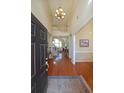 Grand foyer with hardwood floors, soaring ceilings, and an elegant chandelier at 4584 Madison Place Ln, Atlanta, GA 30360