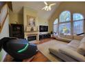 Bright, airy living room featuring high ceilings, a fireplace, and large windows with lots of natural light at 4584 Madison Place Ln, Atlanta, GA 30360