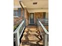 Inviting front porch with brick steps and painted railings, showcasing the home's entrance at 1010 Wesley Park Sw Dr, Marietta, GA 30064