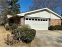 Garage with a brick facade and carriage doors at 1010 Wesley Park Sw Dr, Marietta, GA 30064