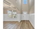 Bright entryway with wood-look flooring, wainscotting, trey ceiling, and lots of natural light at 1734 Cadence St, Locust Grove, GA 30248