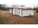 View of an exterior outbuilding with a covered area and an enclosed shed at 2084 North Rd, Snellville, GA 30078