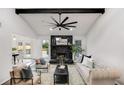 Bright living room with large fan, black stone fireplace, and access to the dining area at 2412 Renny Ct, Marietta, GA 30066