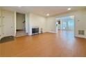 Bright living room with fireplace, wood floors, and staircase access at 3533 Mulberry Way, Duluth, GA 30096