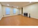 Bright living room with fireplace, recessed lighting, and wood-look floors at 3533 Mulberry Way, Duluth, GA 30096