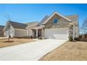 Charming single-Gathering home featuring a stone facade, two-car garage, and a cozy front porch at 2764 Bateman Sw St, Powder Springs, GA 30127