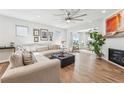 Spacious living room with fireplace, plush sectional, wood flooring, and bright natural light at 2764 Bateman Sw St, Powder Springs, GA 30127
