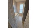 Bathroom featuring a window for natural light, a toilet, and white cabinets at 3121 Baywood Ct, Conyers, GA 30013