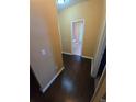 Hallway with hardwood floors leading to bathroom with natural light at 3121 Baywood Ct, Conyers, GA 30013