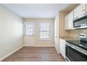 Bright kitchen has white cabinets, granite countertops, stainless steel appliances, and a door to the backyard at 433 Kara Ln, Mcdonough, GA 30253