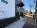 Townhome entrance with painted brick, minimalist black awning, and tasteful landscaping at 827 Winslow Nw Way, Atlanta, GA 30318