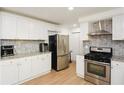 Well-equipped kitchen features stainless steel appliances, white cabinetry and granite countertops at 2133 Creekview Trl, Decatur, GA 30035