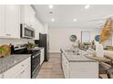 Bright kitchen boasts granite counters, stainless appliances, ample cabinet space, and an inviting breakfast bar at 340 Sinclair Ct # 75, Mcdonough, GA 30253