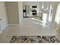 Open kitchen with stainless steel appliances, white cabinets, and lots of natural light at 3577 N Winds N Trl, Douglasville, GA 30135