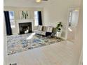 Bright living room with light wood floors, fireplace, and large windows with natural light at 3577 N Winds N Trl, Douglasville, GA 30135