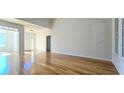 Bright living room featuring gleaming hardwood floors and a view of the home's entry at 4875 Gladstone Pkwy, Suwanee, GA 30024