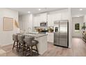 Modern kitchen with stainless steel appliances, granite countertops, and eat in island at 541 Tuskegee St, Mcdonough, GA 30253