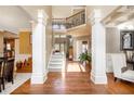 Elegant foyer featuring hardwood floors, decorative columns, and a staircase leading to the second floor at 2785 Old Sewell Rd, Marietta, GA 30068