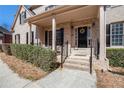 Inviting front porch with brick steps, iron railings, and a decorative wreath on the front door offering a warm welcome at 2785 Old Sewell Rd, Marietta, GA 30068