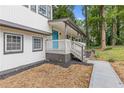 Cozy covered front porch with blue door and manicured landscaping at 353 Old Rosser Rd, Stone Mountain, GA 30087