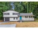 Charming home features a front porch with a blue door and nice curb appeal at 353 Old Rosser Rd, Stone Mountain, GA 30087