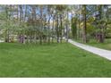 Long driveway leading to the home through a lush, wooded landscape at 612 Saddlewood Dr, Lawrenceville, GA 30043