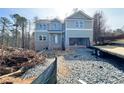 New construction of two-story home with an attached two-car garage at 66 Pine Creek Ct, Dallas, GA 30157