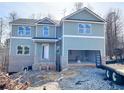 New construction of two-story home with a large attached two car garage at 66 Pine Creek Ct, Dallas, GA 30157