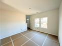 Bright, unfinished living room featuring clean white walls and abundant natural light, awaiting your personal touch at 66 Pine Creek Ct, Dallas, GA 30157