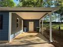 A covered carport area provides shelter with a white door leading to additional space at 1504 Sycamore Nw Dr, Kennesaw, GA 30152