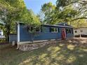 Cozy blue home with charming front yard landscaping, including a stone retaining wall at 1504 Sycamore Nw Dr, Kennesaw, GA 30152