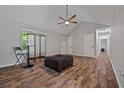 Spacious living room with vaulted ceiling, featuring a ceiling fan and neutral color scheme at 28 Fawn Ct, Sharpsburg, GA 30277