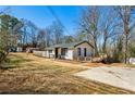 Exterior view of this residence includes a driveway and back deck at 105 Huskins Rd, Canton, GA 30115